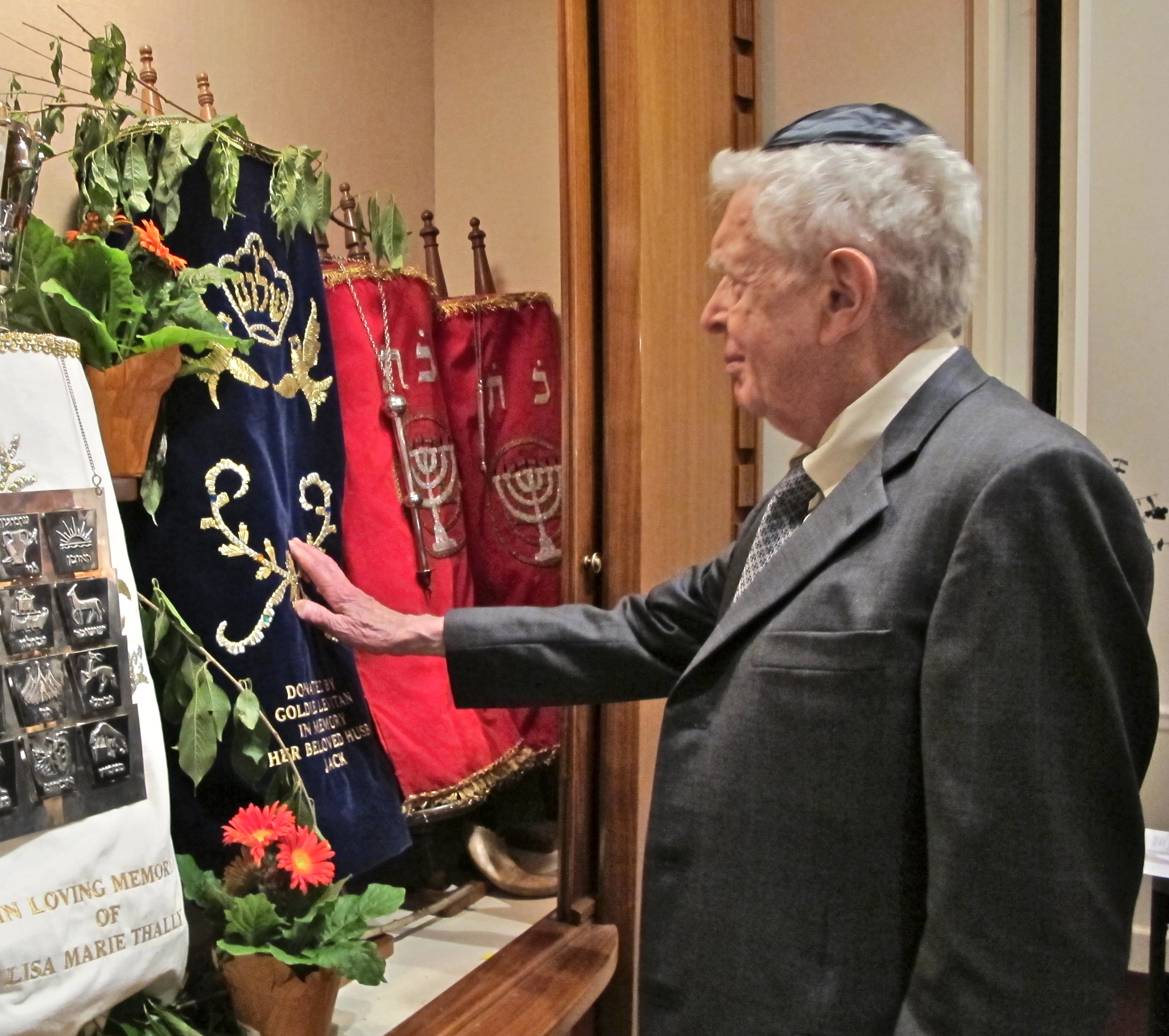 Immanuel touching the Torahs.